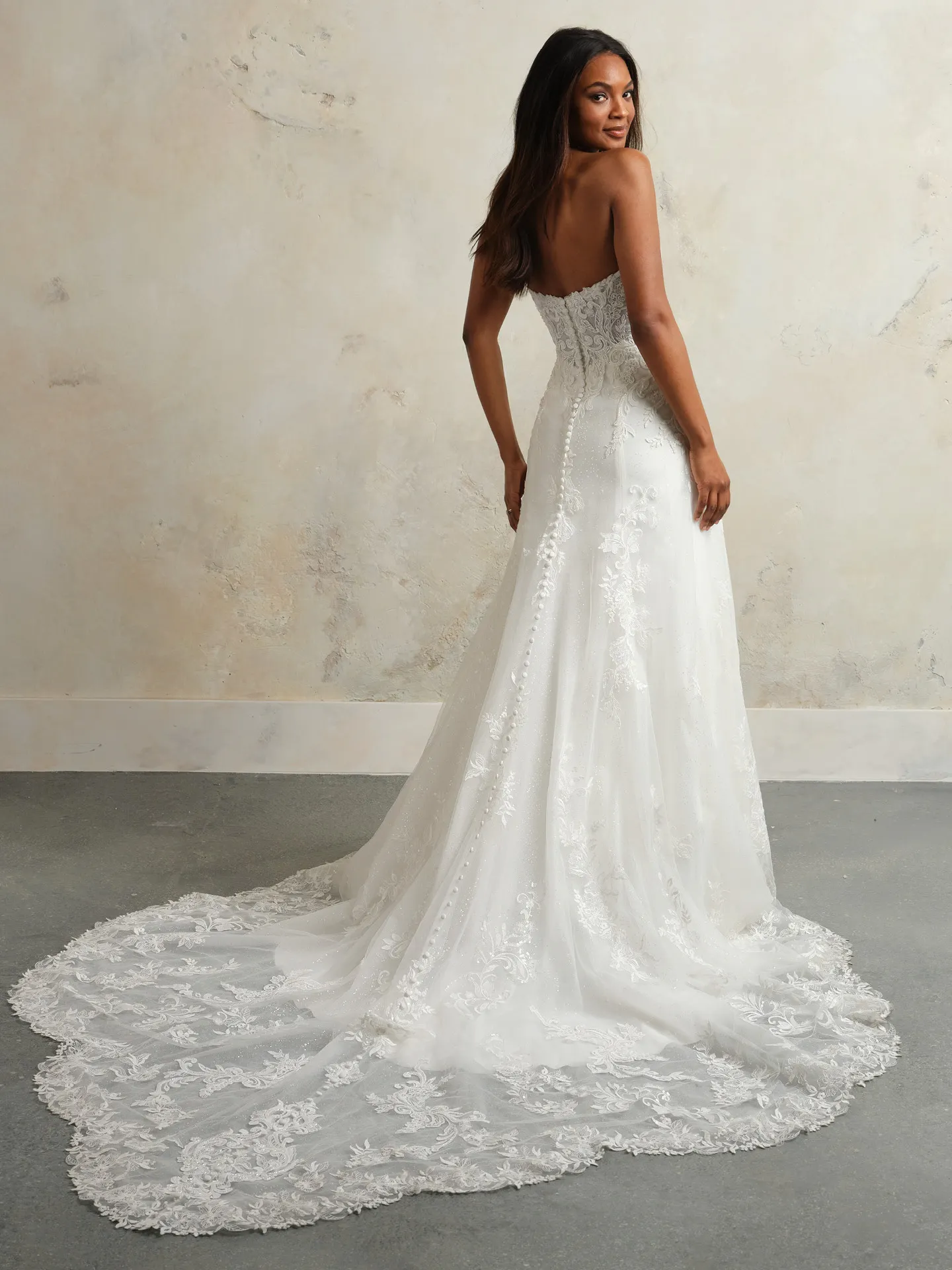 Maggie Sottero Lavish A-Line back view with glittering lace details.