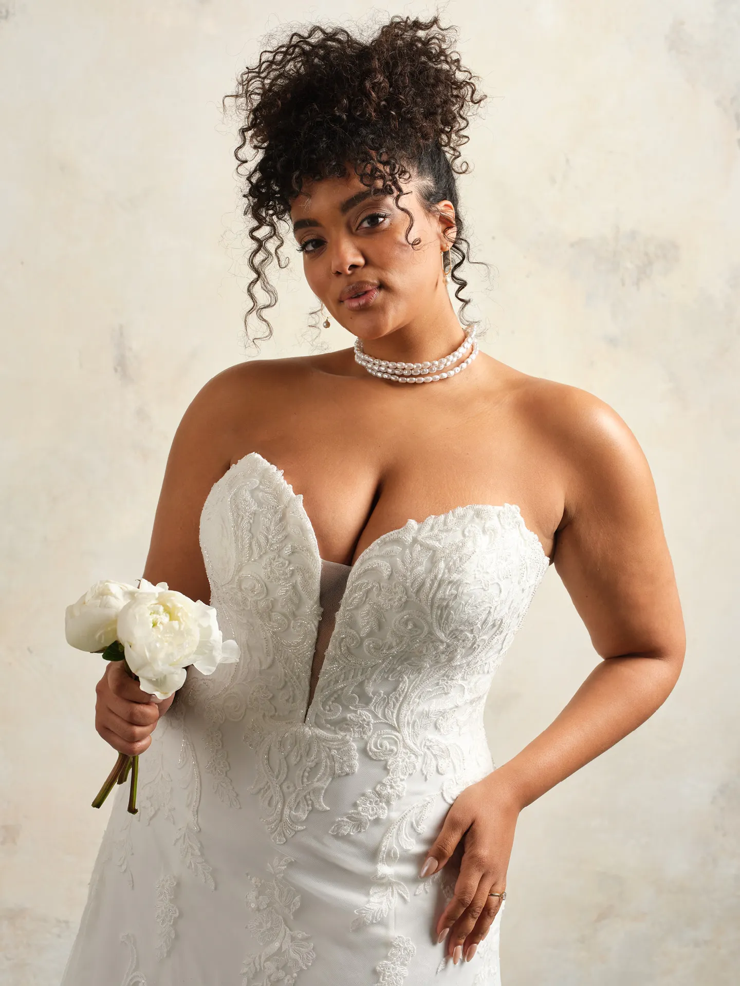 Maggie Sottero Lavish Kyler front view A-line lace detail with bouquet