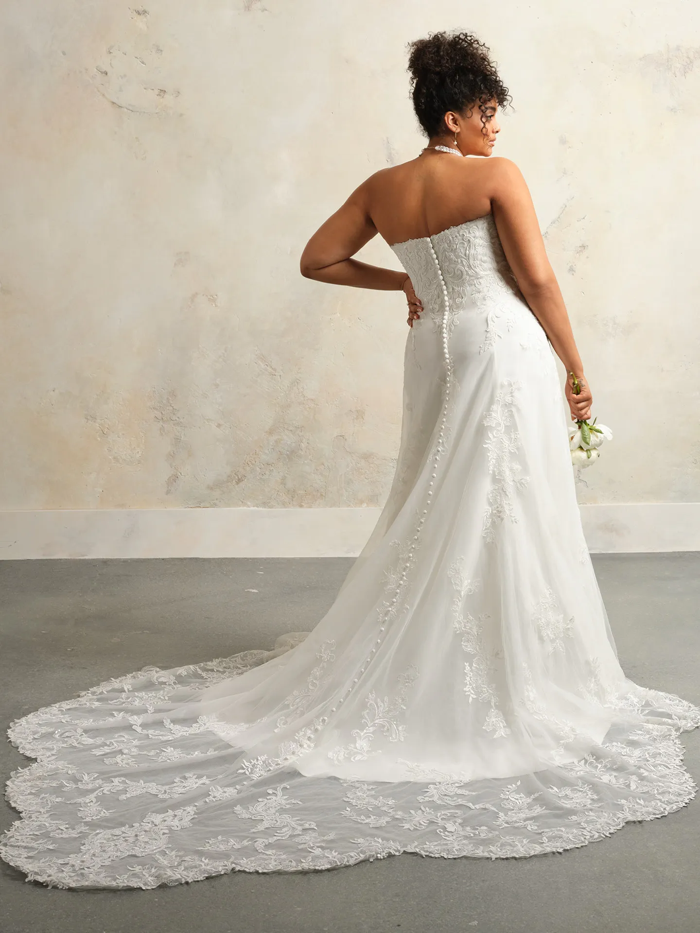 Maggie Sottero Kyler back view lace A-Line wedding dress with long train