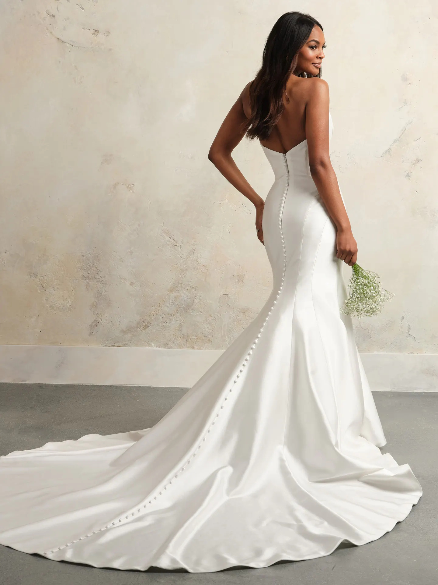 Rebecca Ingram Leilani back view satin gown with draped bodice and button details.