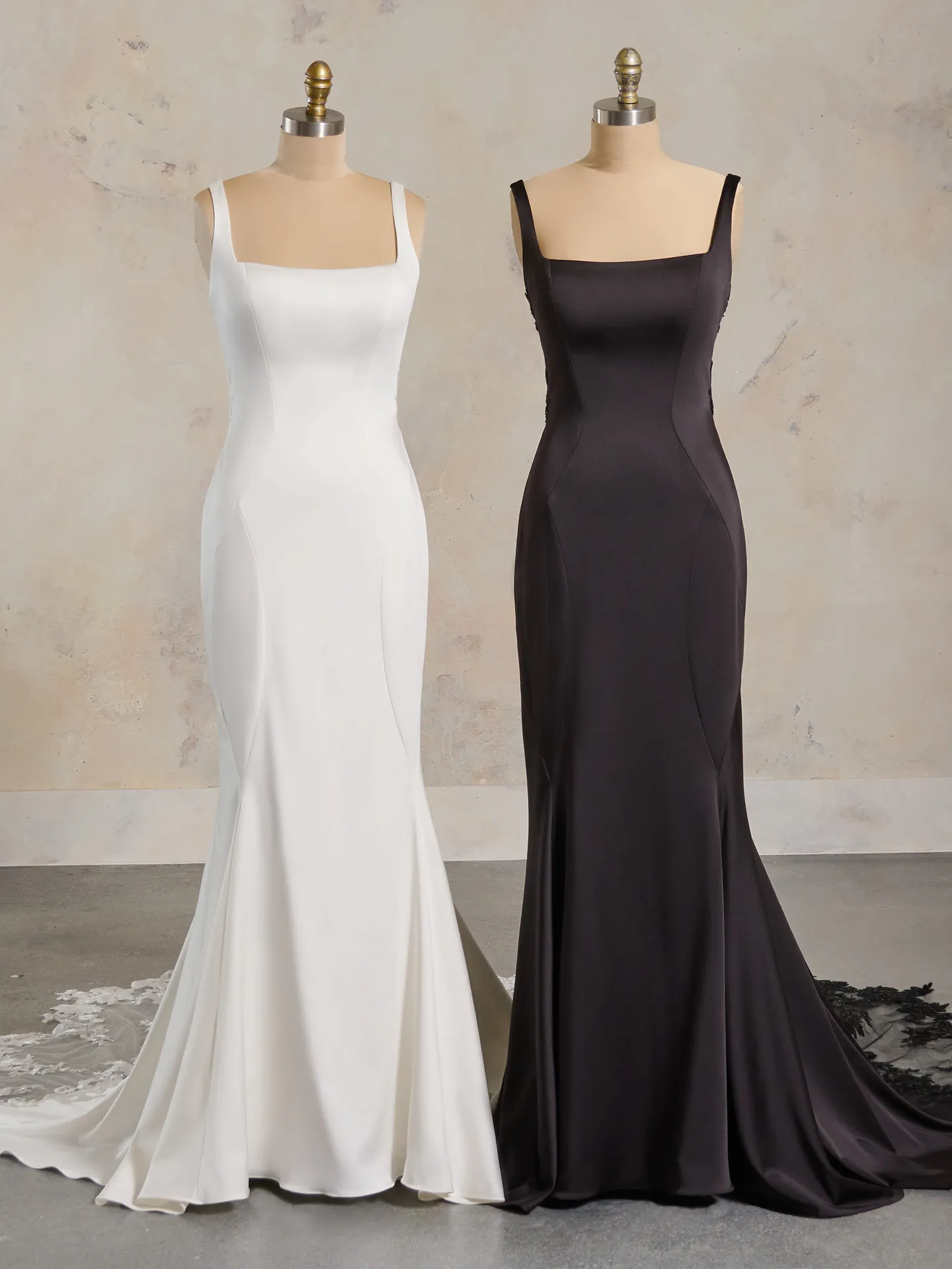 Maggie Sottero Vivica satin mermaid dresses in white and black on mannequins.