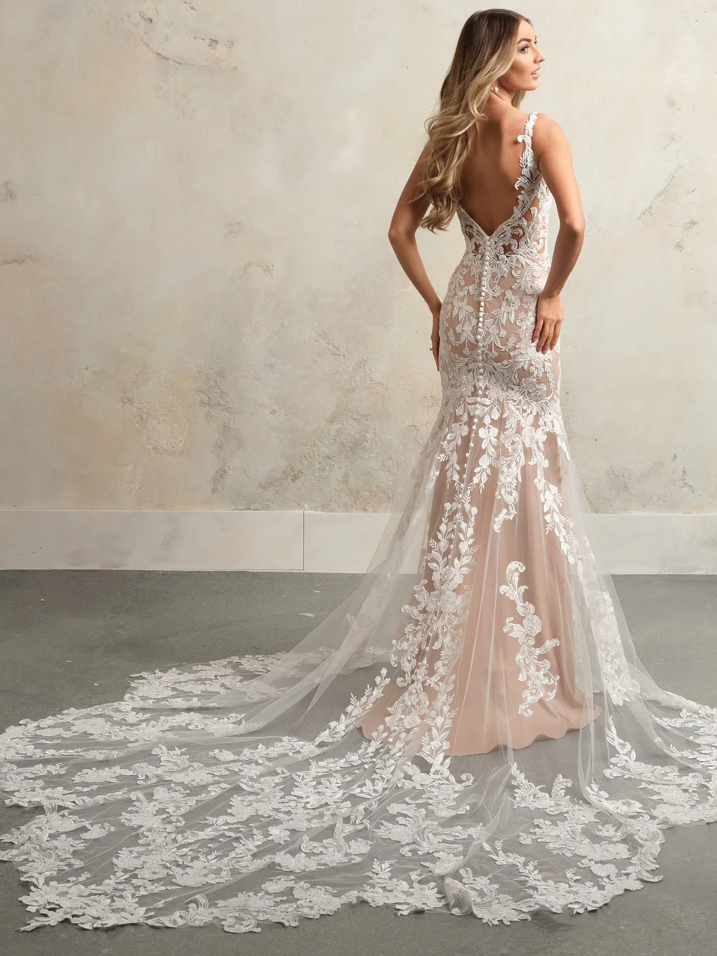 Maggie Sottero Zeta mermaid gown back view with lace and tulle details.