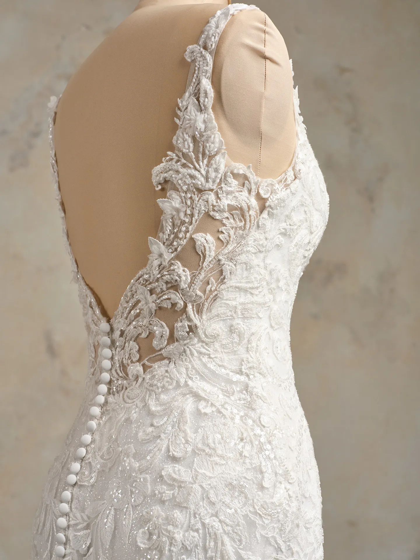Maggie Sottero Zeta lace side view with intricate tulle and button back detailing.