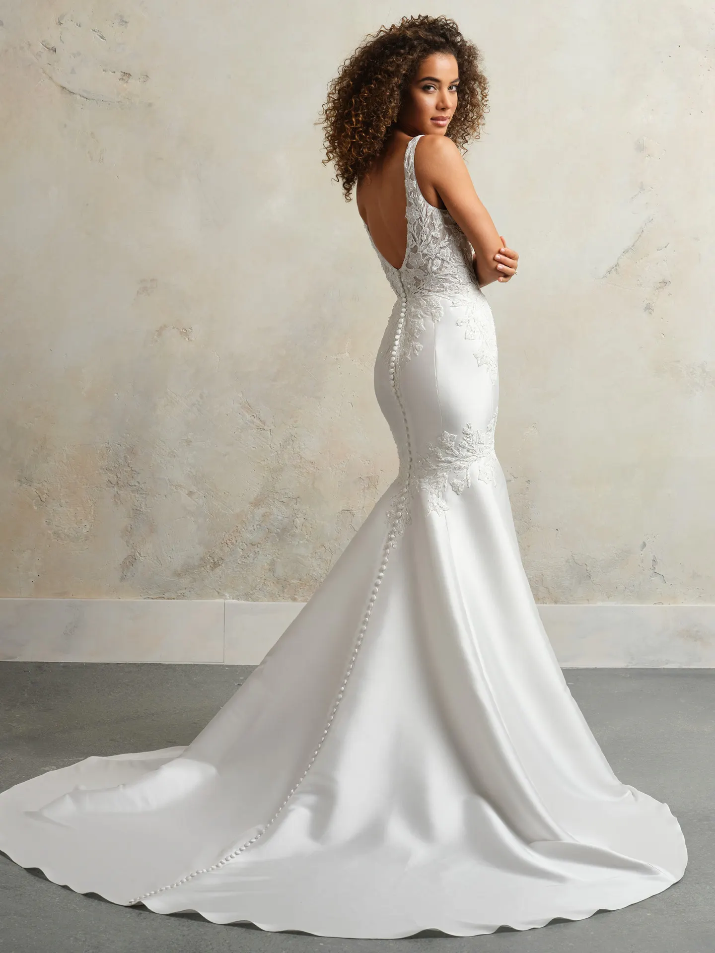 Maggie Sottero fit-and-flare bridal dress back view with plunge neckline and button detail