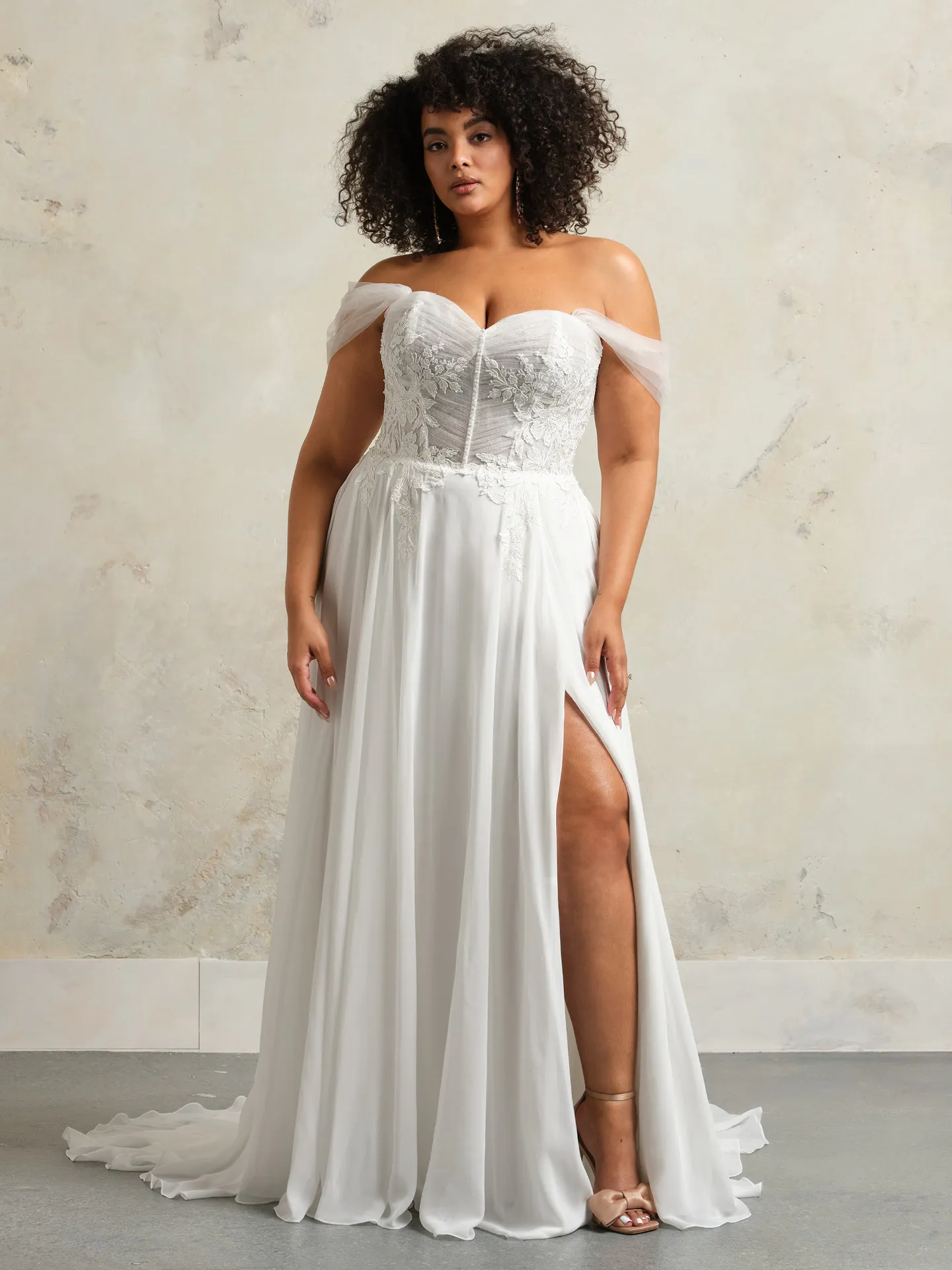 Maggie Sottero Blake front view, flowy tulle corset gown with pearls and slit.