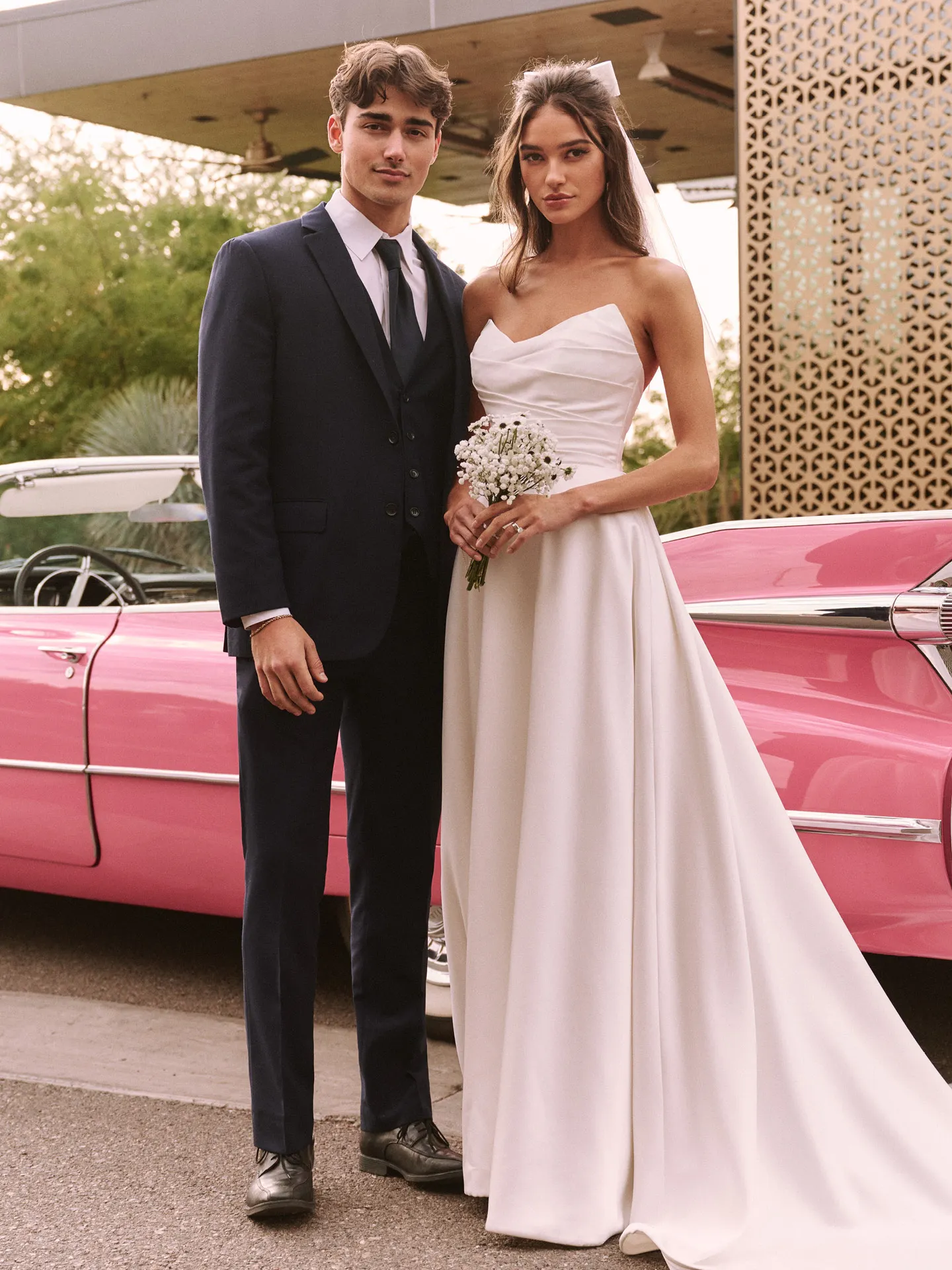 Rebecca Ingram Ethelinda front view strapless gown with pink vintage car