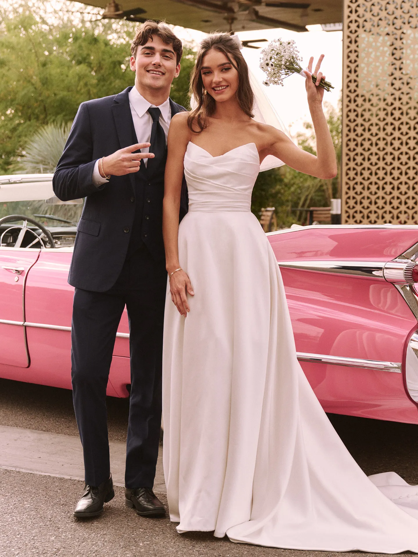 Ethelinda wedding dress front view with pink car in background.