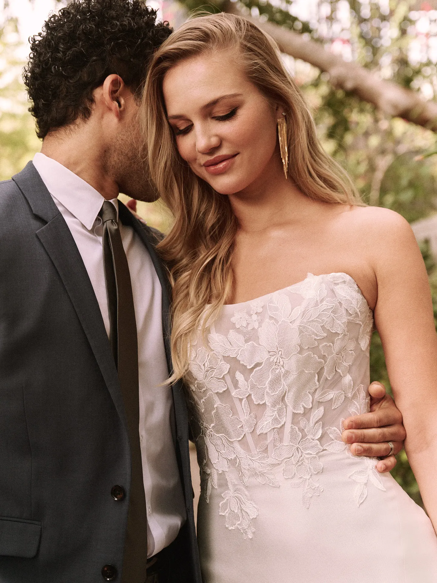 Romantic Goldie lace dress front view in outdoor setting, strapless floral bodice detail.