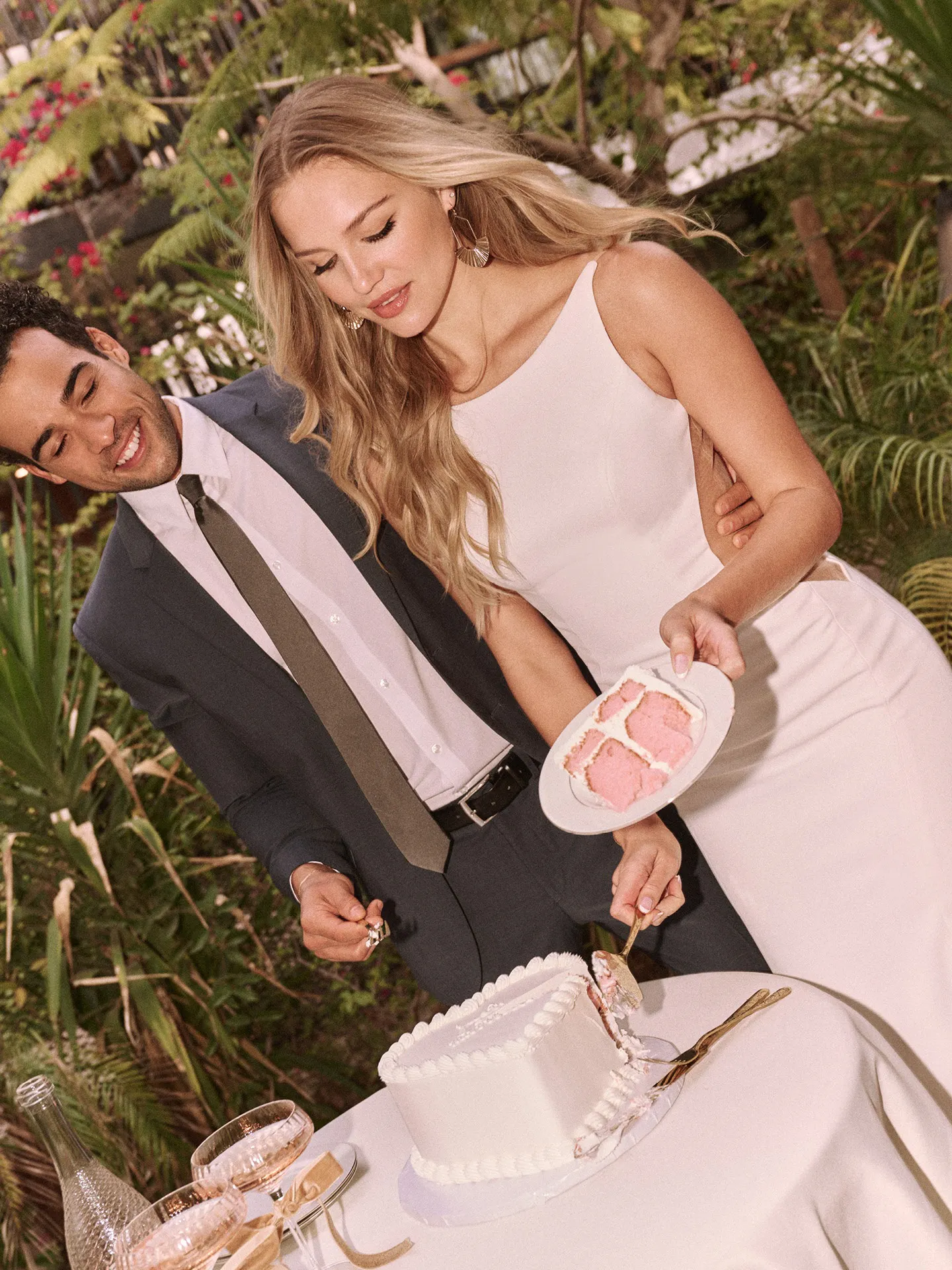 Rebecca Ingram Hope front view scoop neckline wedding dress at garden table.