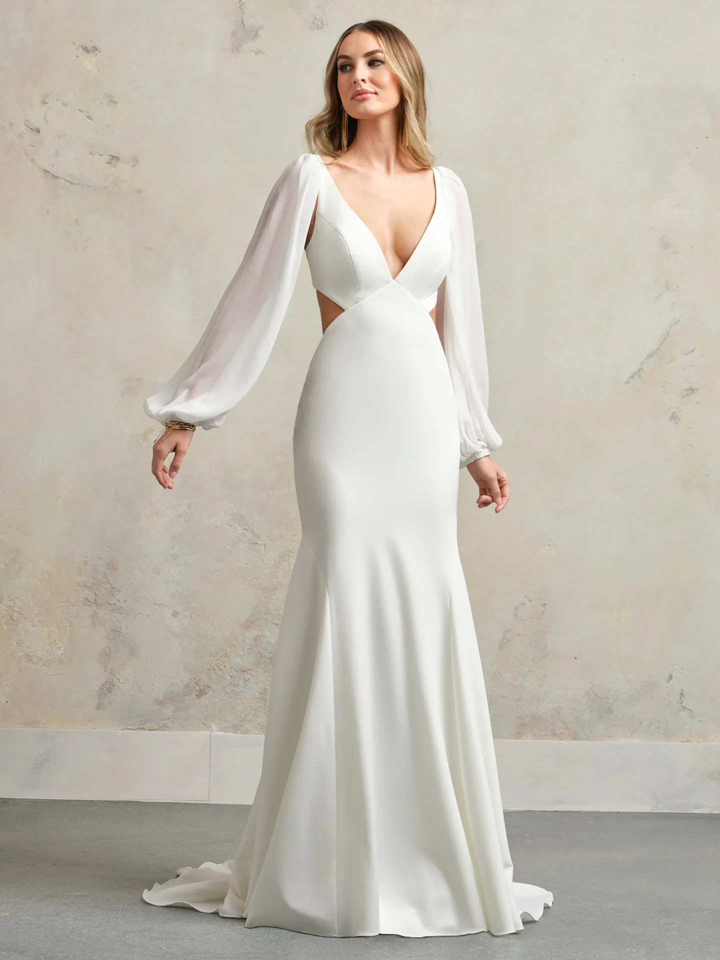 Maggie Sottero Kelsey front view, sheer crepe gown with long sleeves and cutout sides.