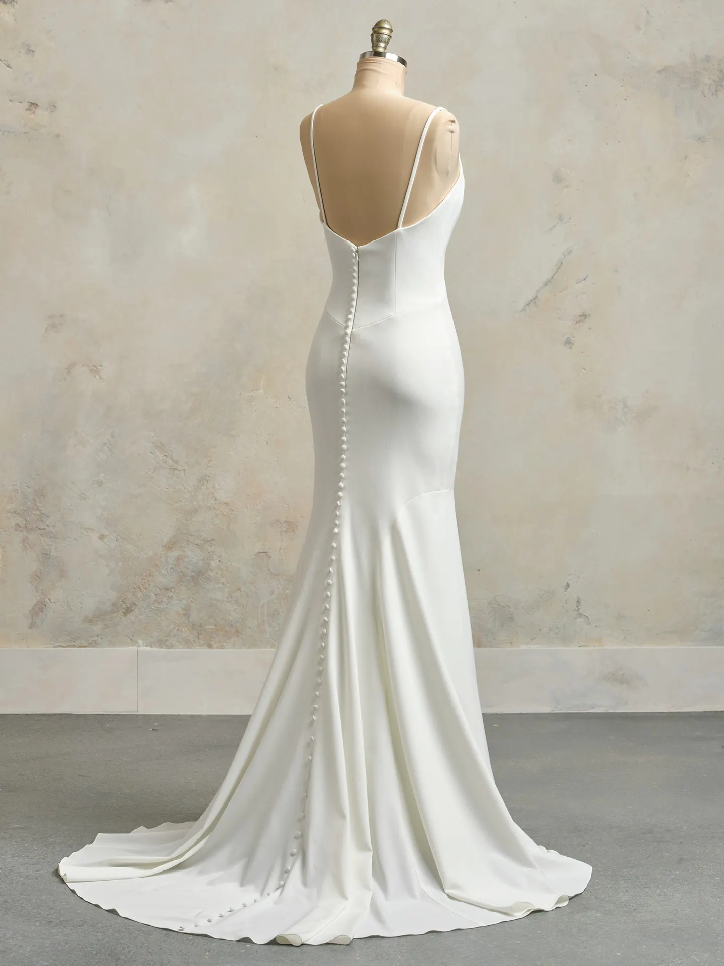 Maggie Sottero Kelsey back view with buttons, crepe fabric, and straps