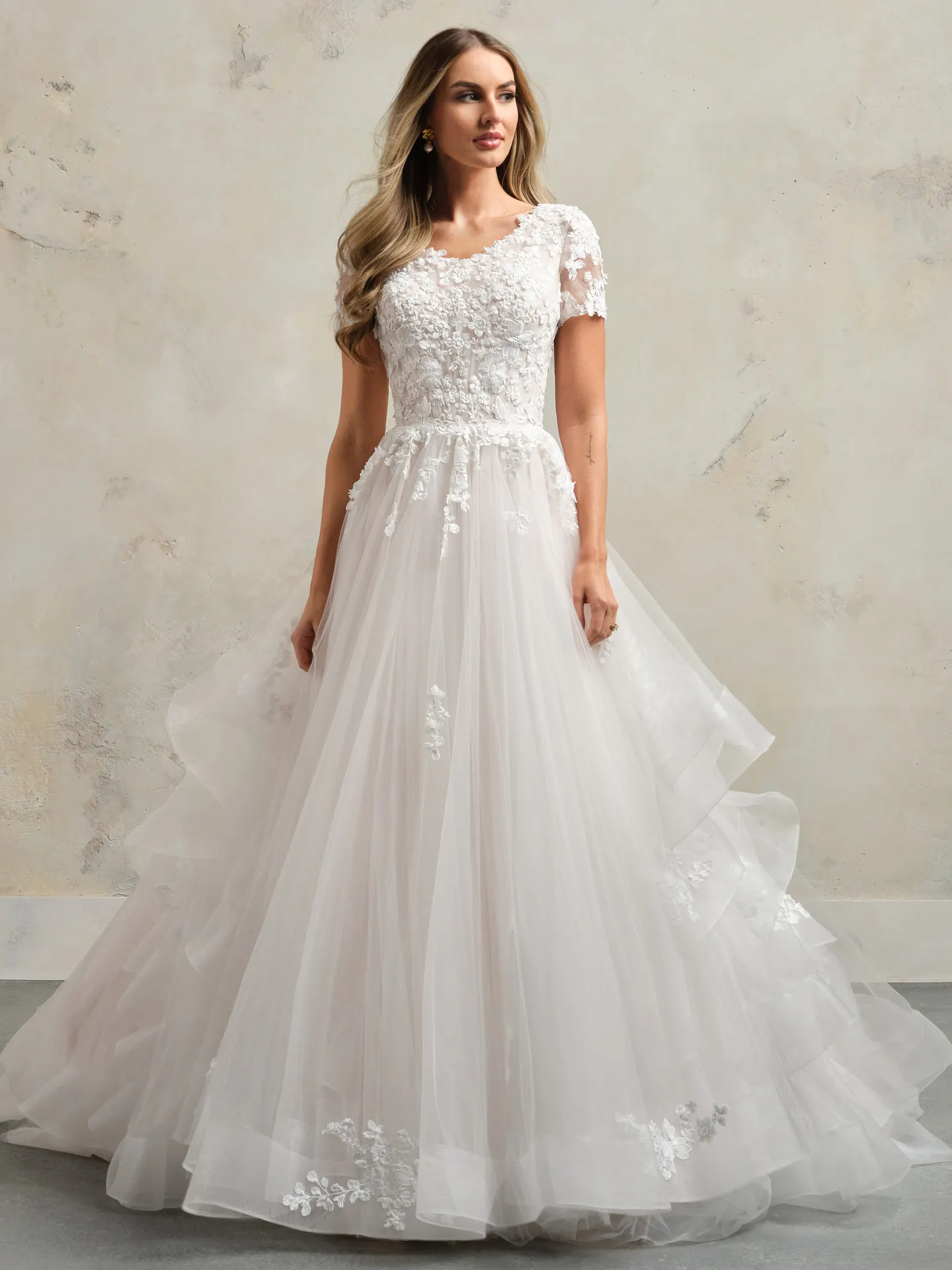 Winona Leigh ball gown front view with floral details and short sleeves.