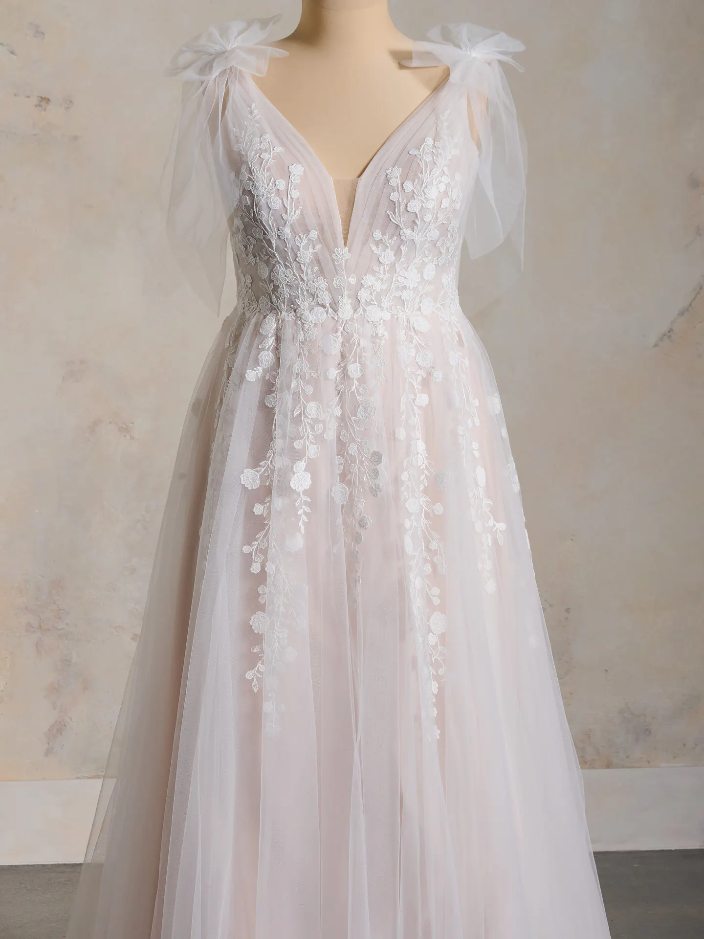 Maggie Sottero V-neck lace bridal gown front view with floral details
