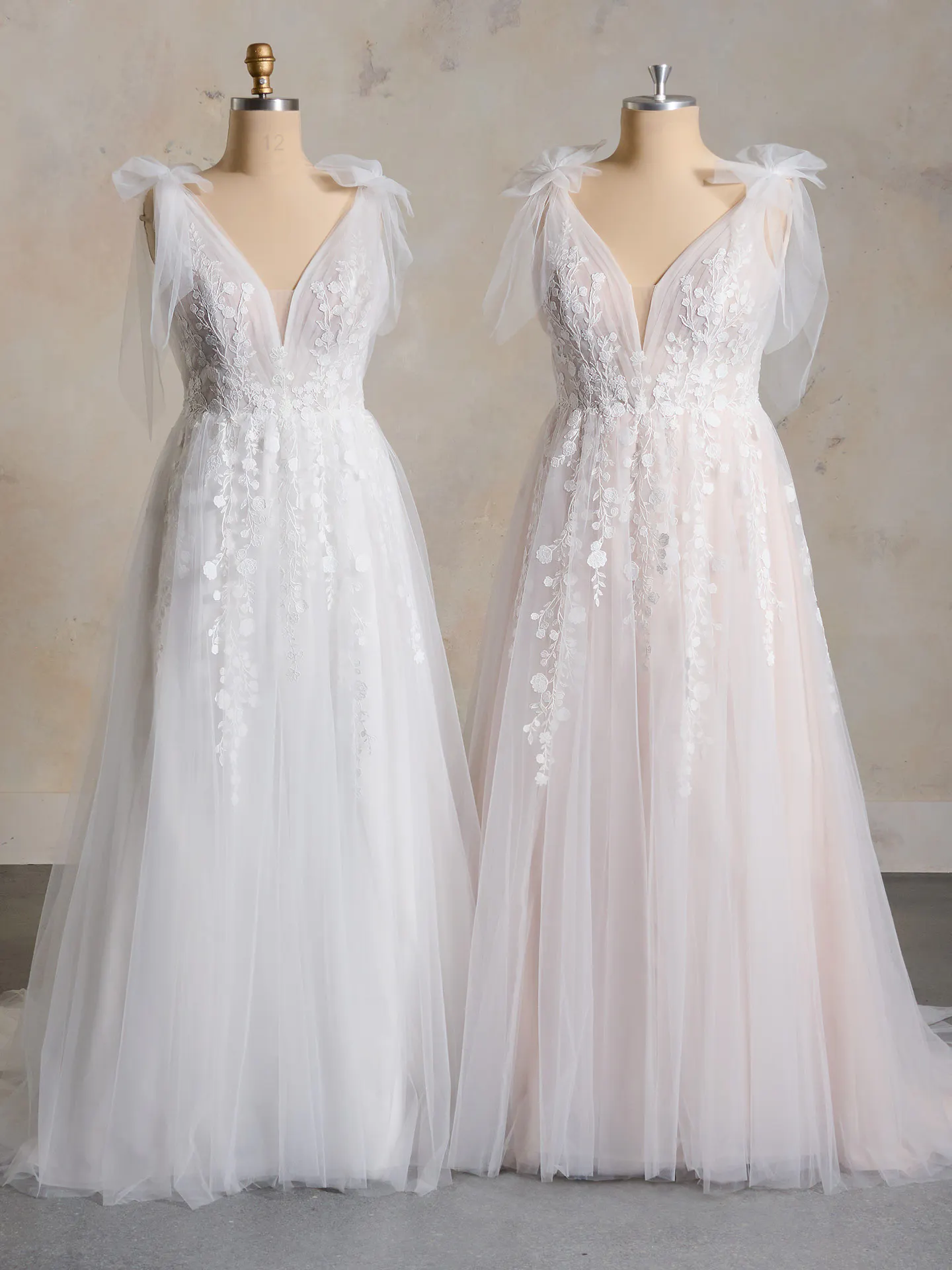 Maggie Sottero V-neck Zinnia lace gowns on mannequins front view.