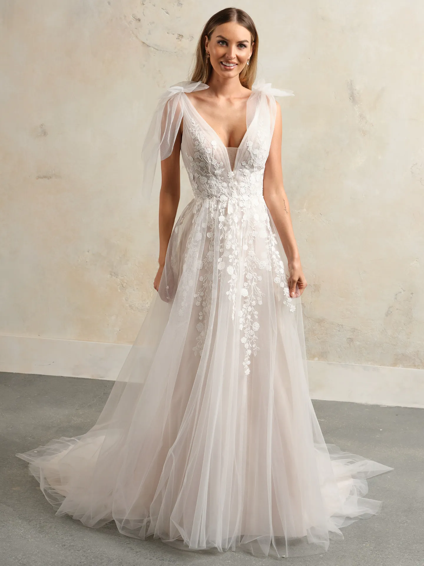 Maggie Sottero flowy floral lace V-neck bridal gown front view