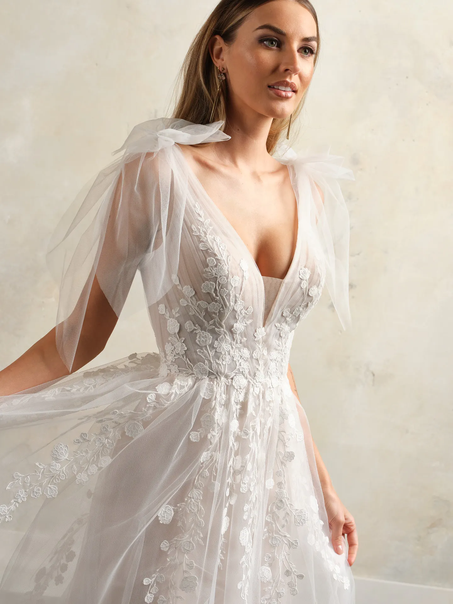 Maggie Sottero flowy V-neck floral lace gown front view