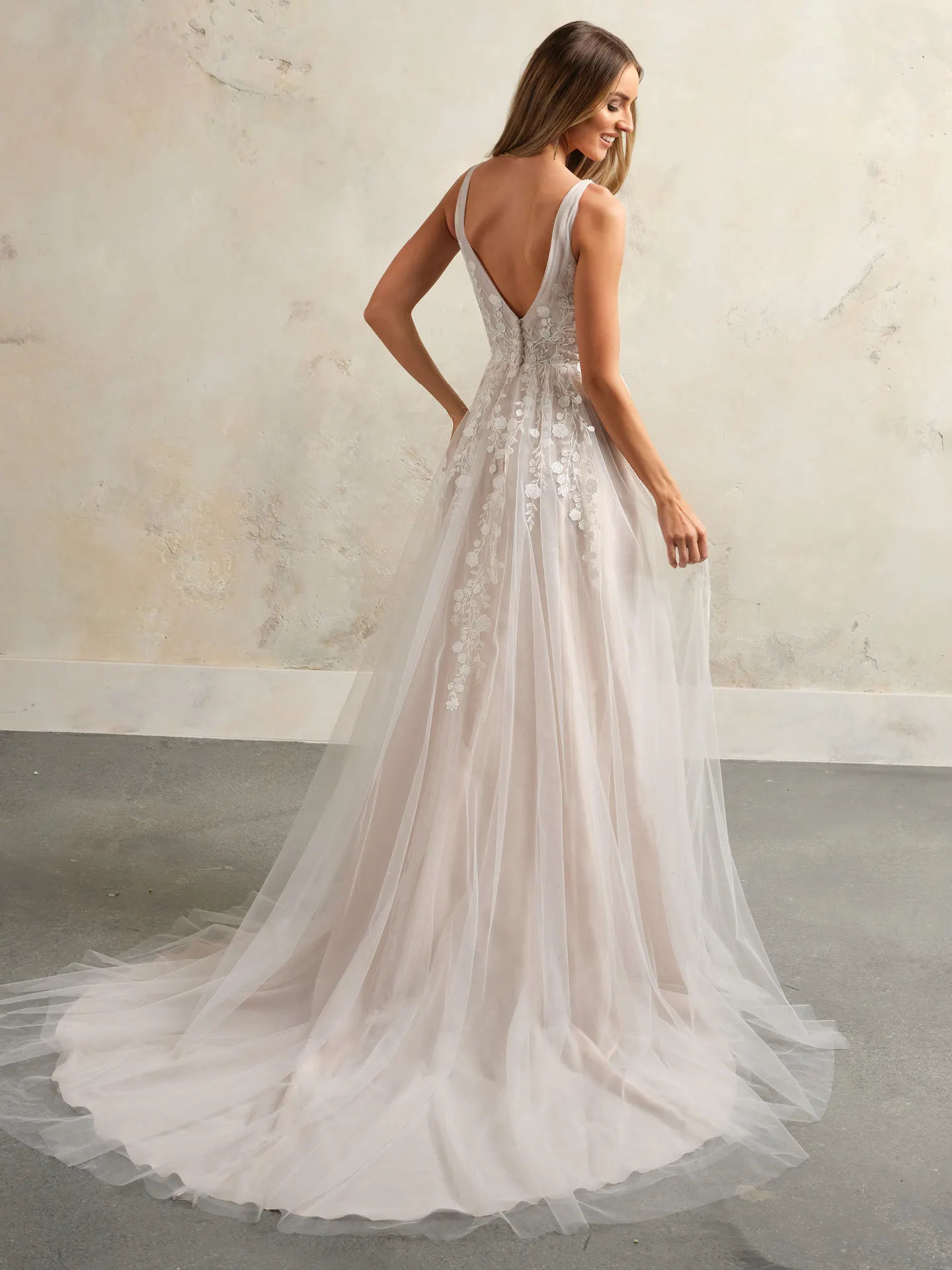 Maggie Sottero flowy floral V-neck bridal gown back view