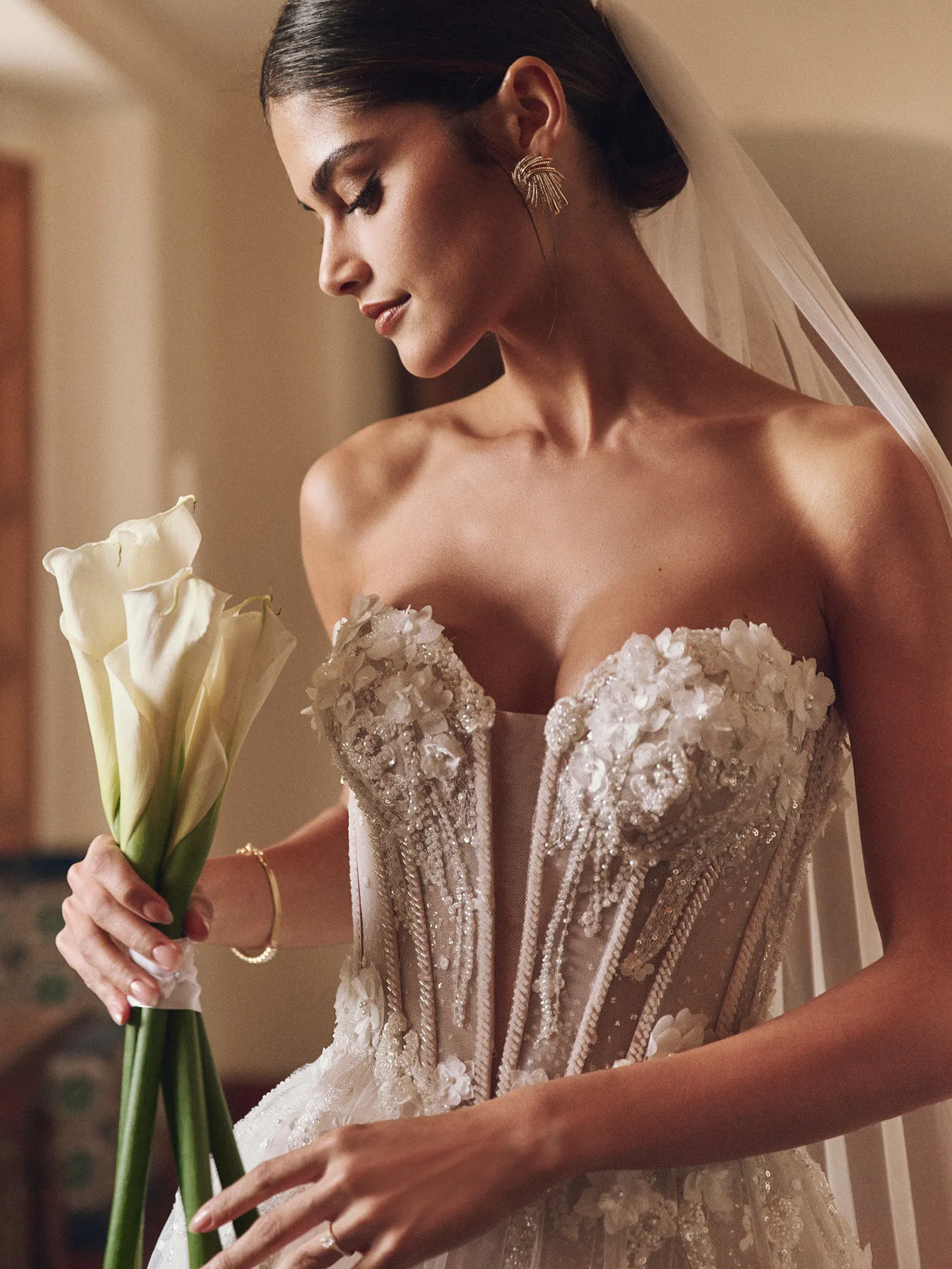 Rebecca Ingram bridal dress with floral embellishments, side view.
