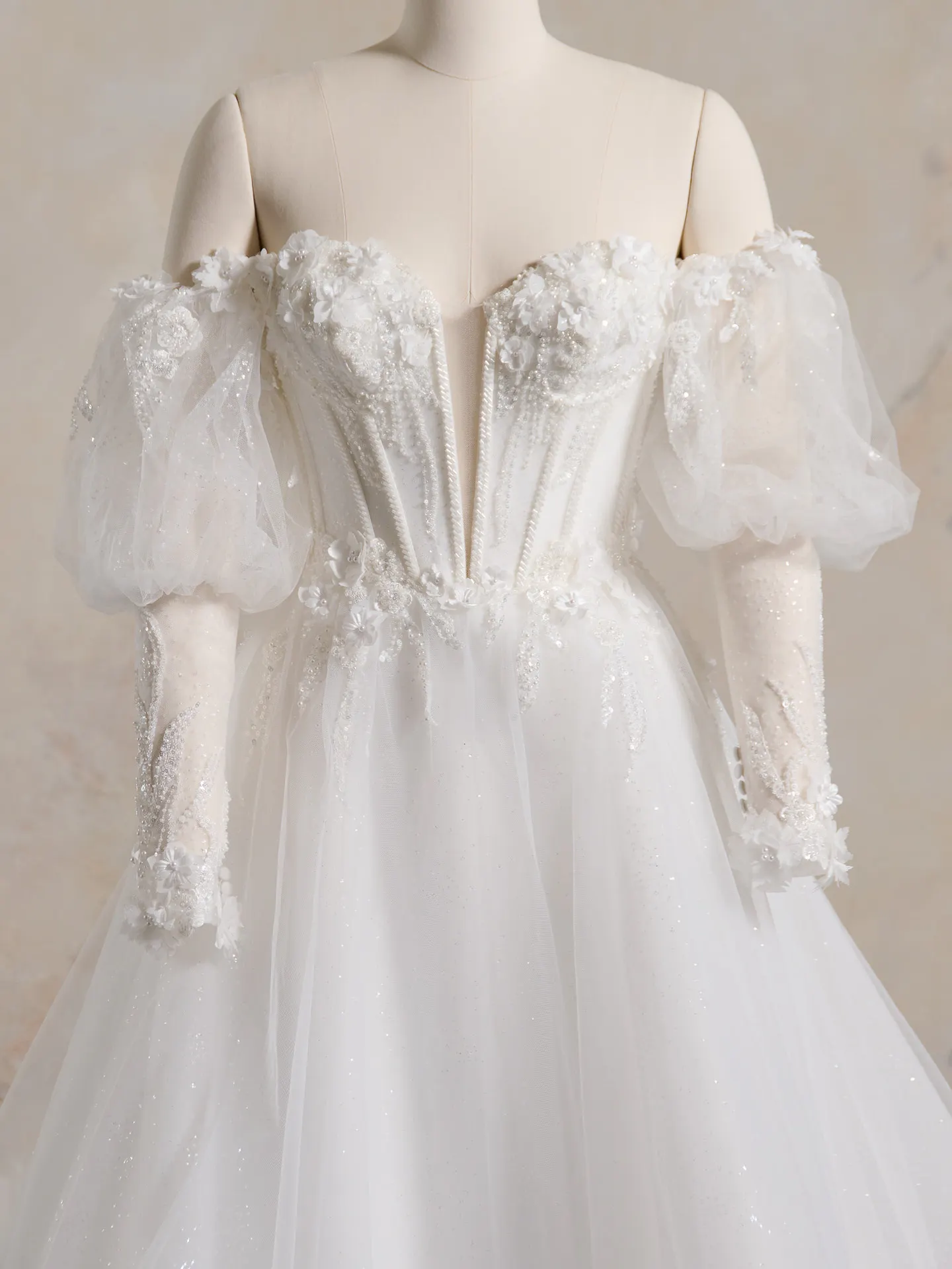 Maggie Sottero ballgown front view with off-shoulder 3-D lace and glitter tulle sleeves.