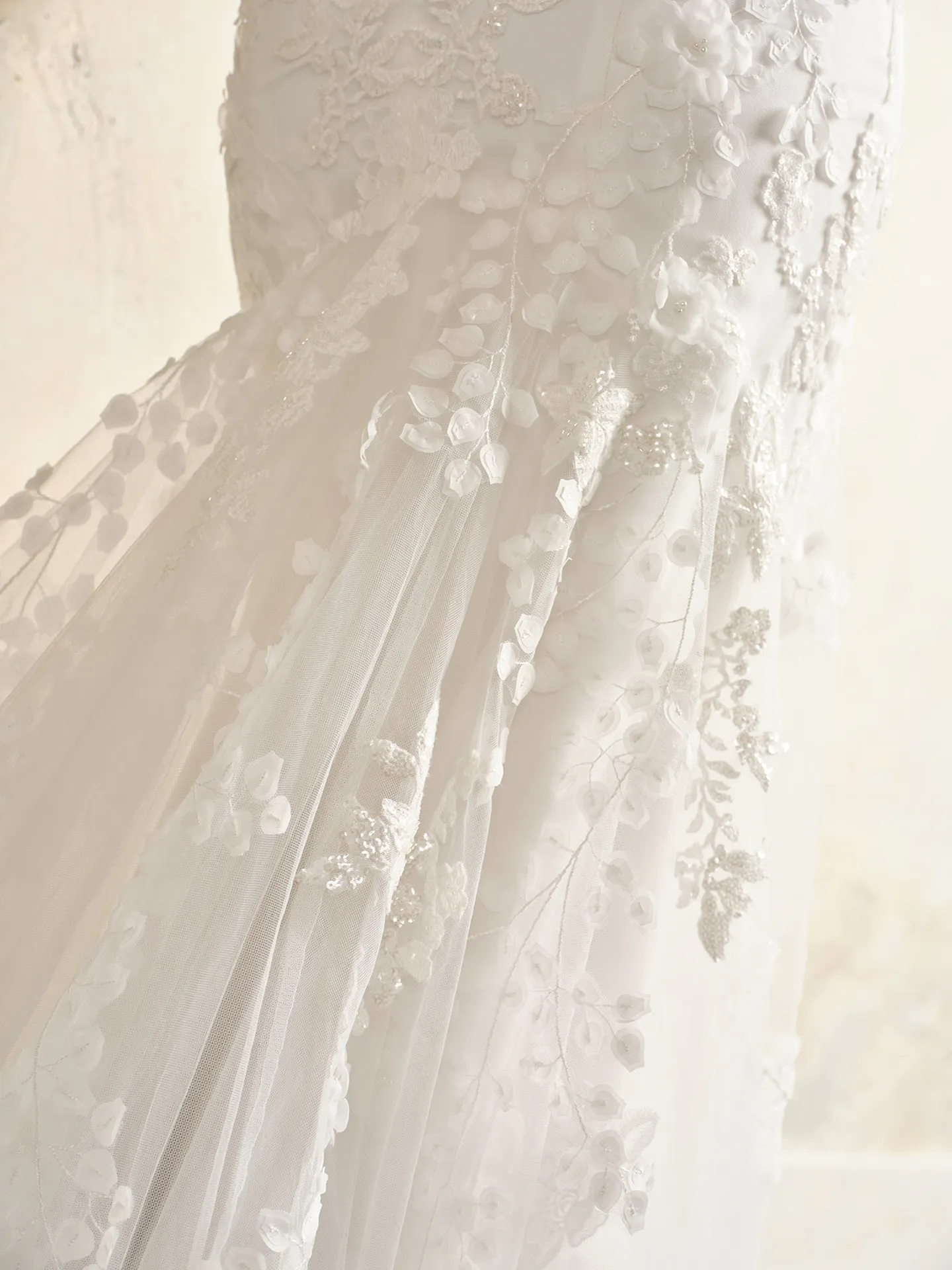 Kellen tulle gown detail with floral crisscross embroidery.