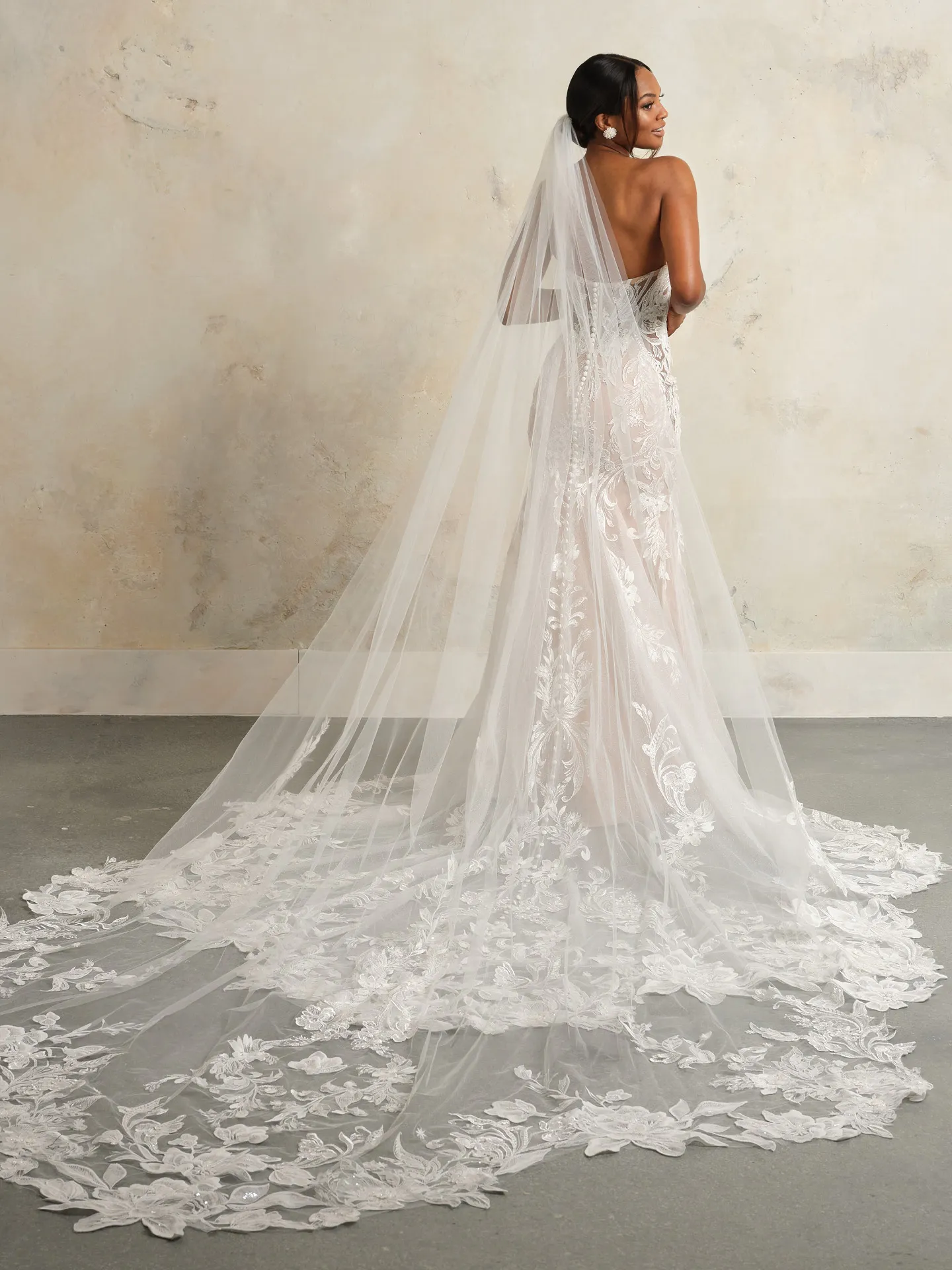 Sottero and Midgley dress back view with royal length scalloped veil and beaded lace.