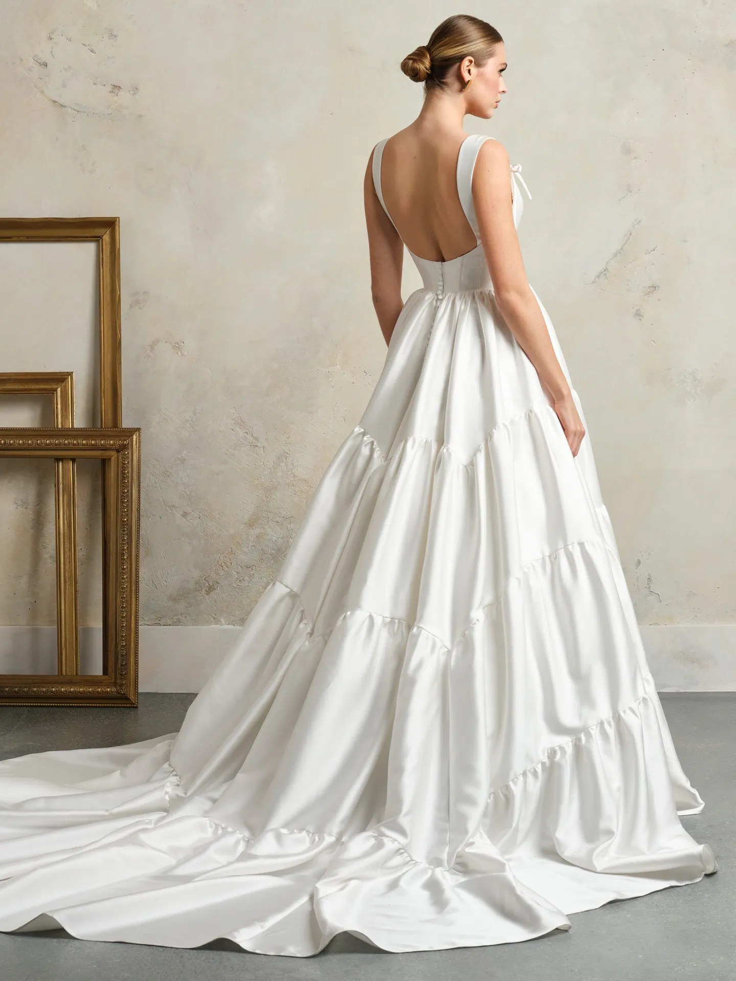 Maggie Sottero wedding dress back view with ruffled layers and low-cut back.