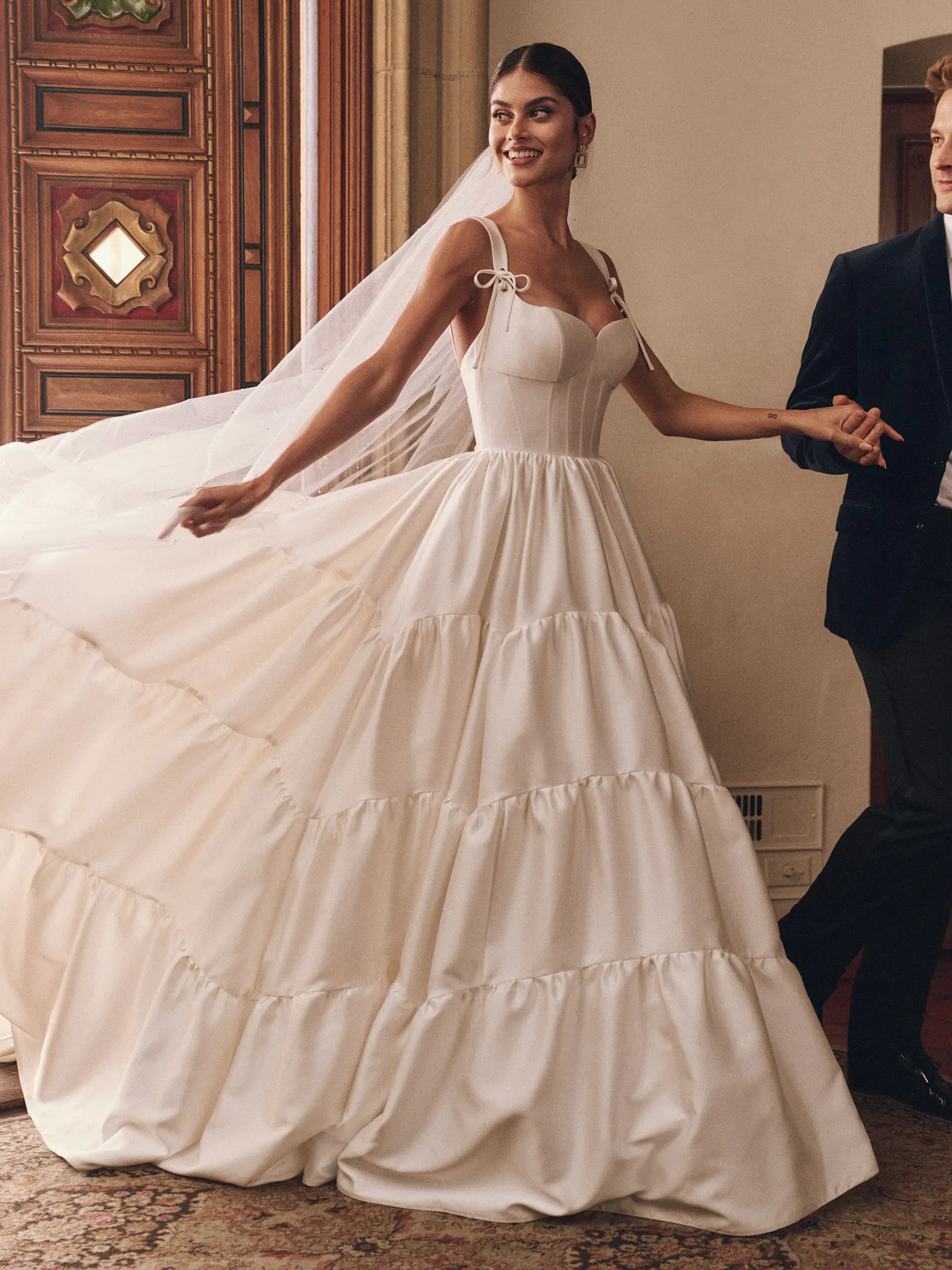 Maggie Sottero ruffled ballgown wedding dress side view with veil