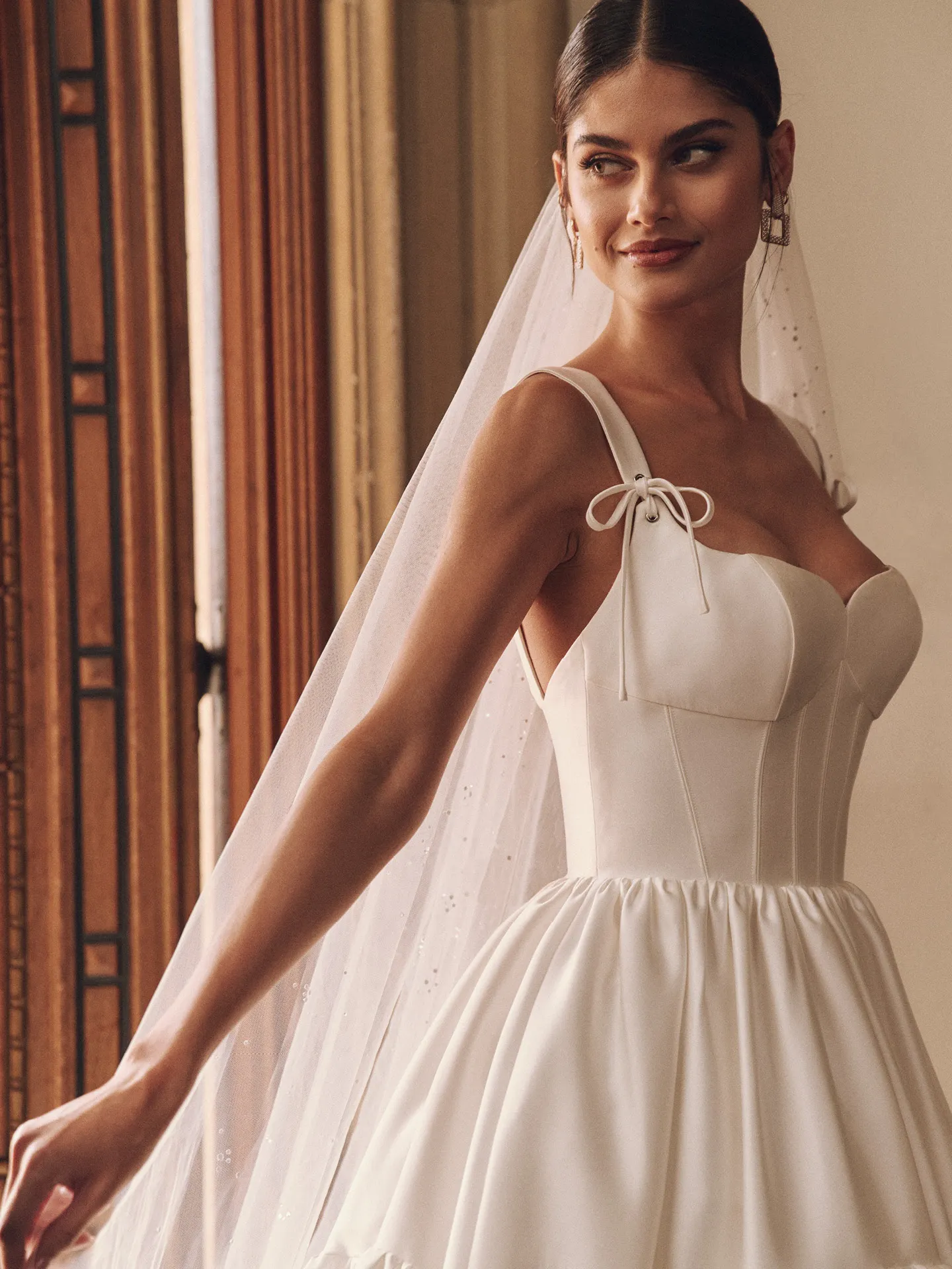 Maggie Sottero wedding dress front view with bow detail and ruffled skirt.