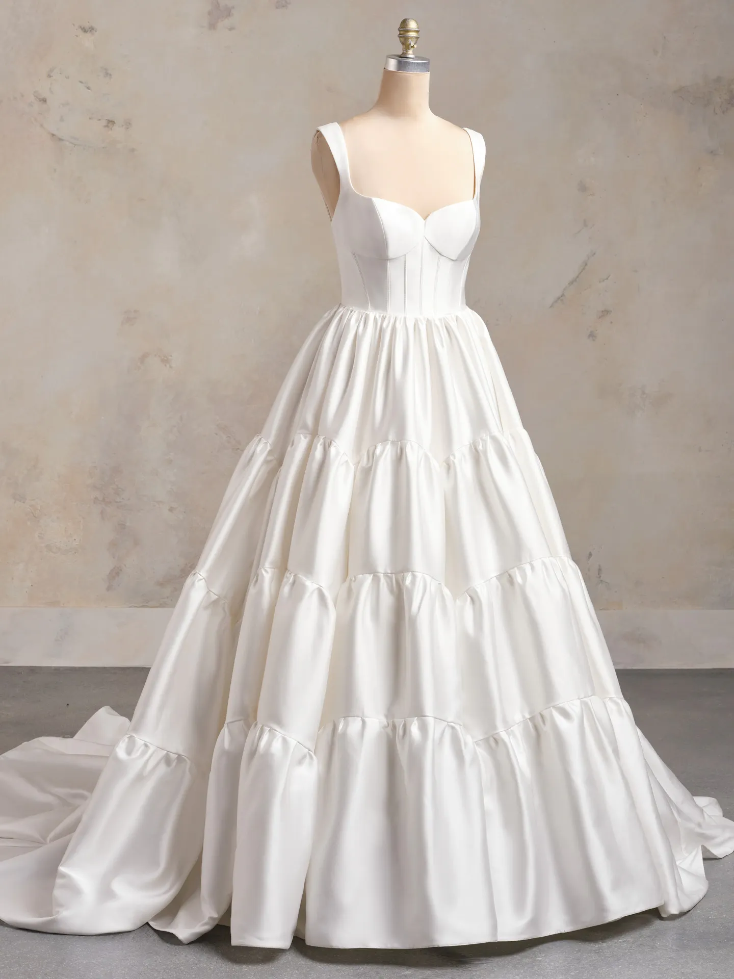 Maggie Sottero ruffled corset wedding dress front view on a mannequin.