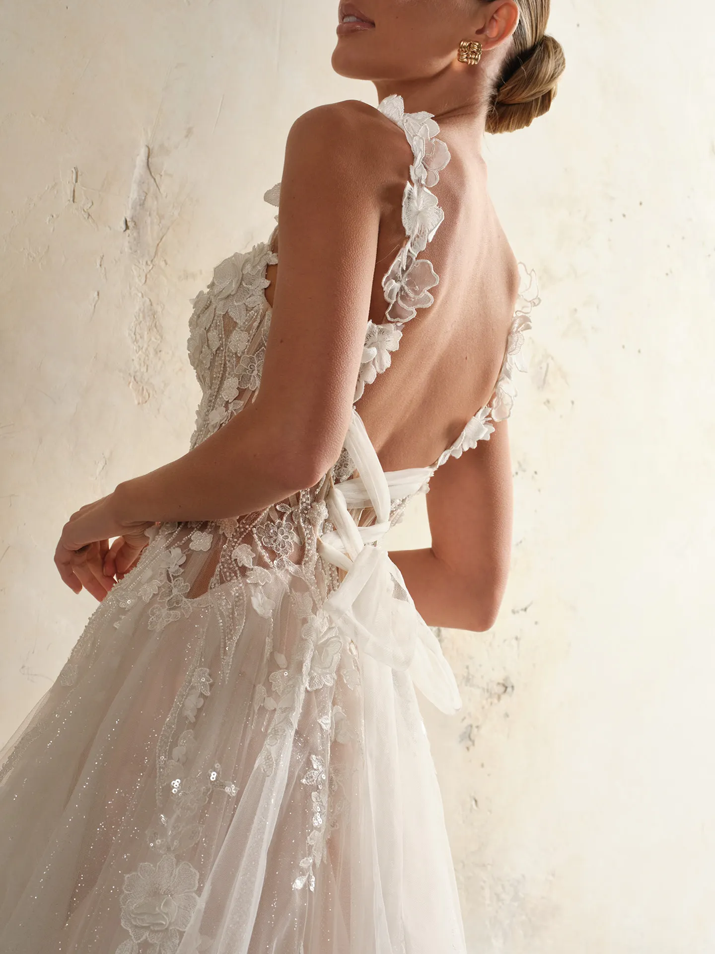 Rebecca Ingram floral back view bridal dress with 3-D flowers and side slit.