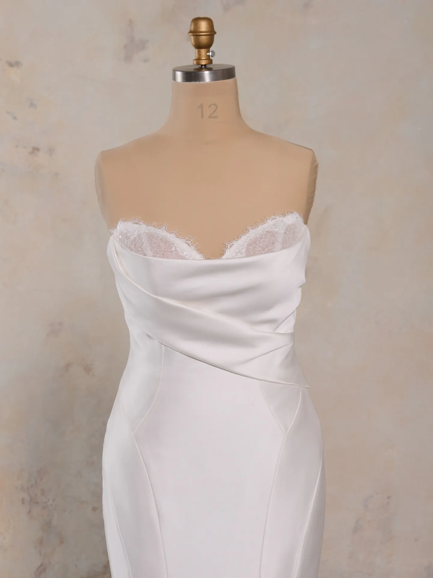 Leilani fit-and-flare dress on mannequin, detail shows lace bodice and pleated neckline.