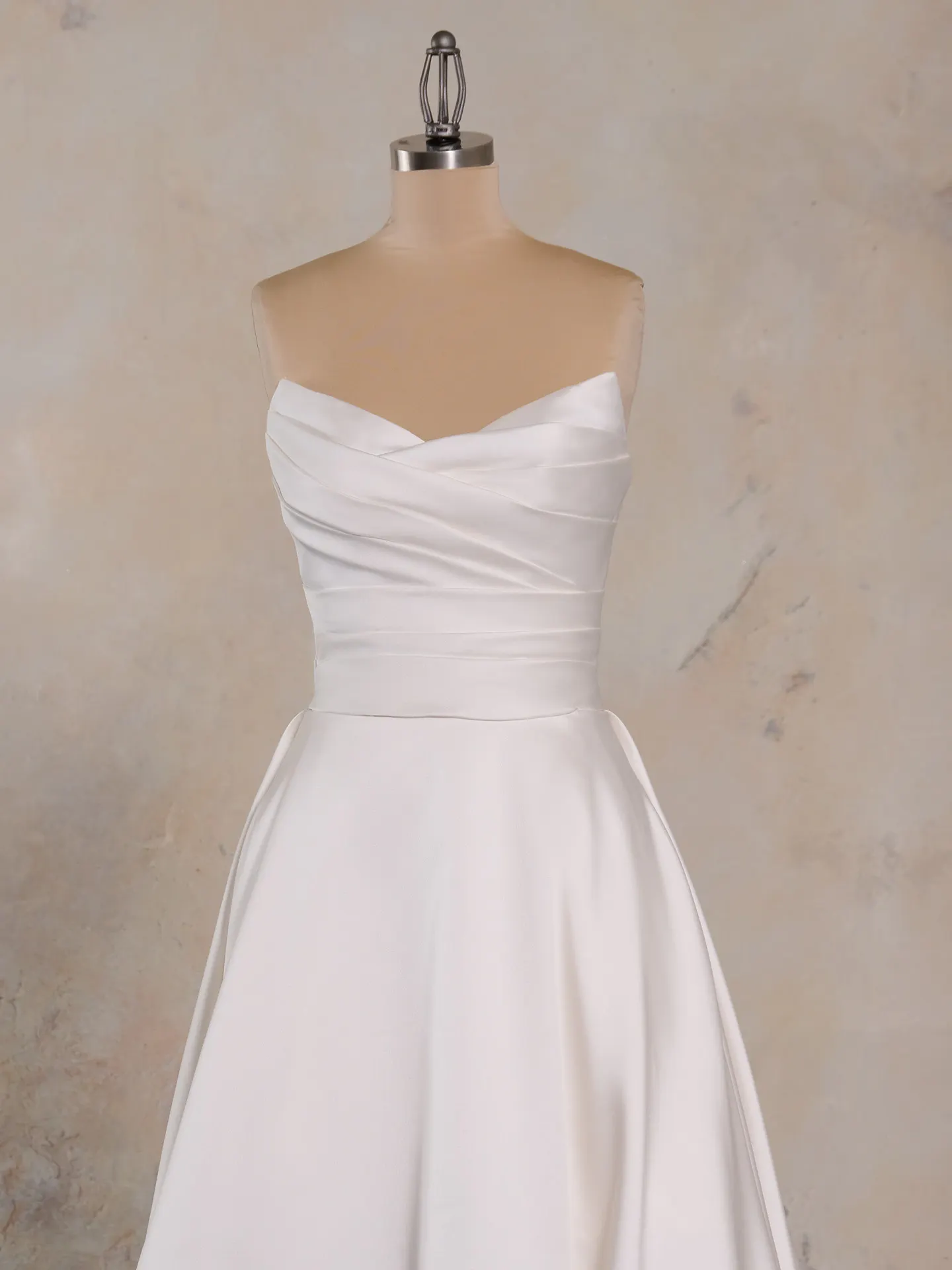 Ethelinda short wedding dress front view strapless satin with pleated bodice displayed on mannequin