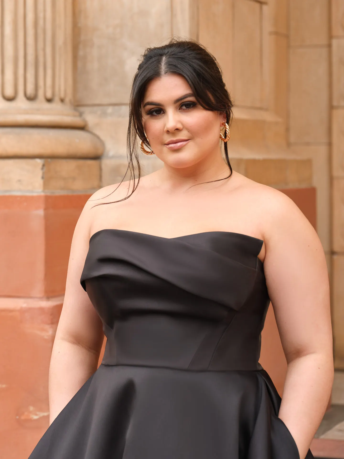 Strapless black asymmetrical draped Mikado gown front view.