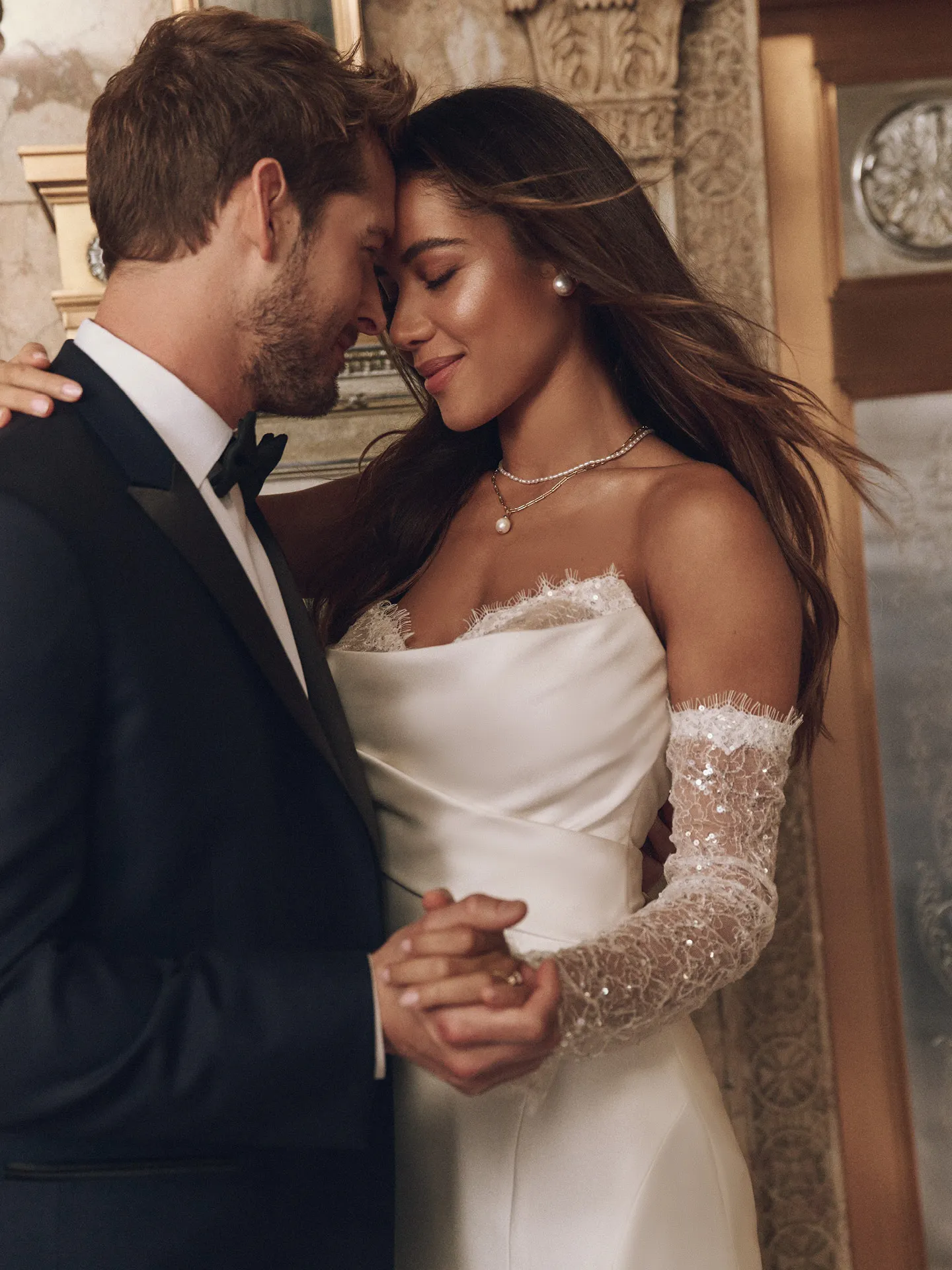 Leilani sequined fit-and-flare bridal dress with lace sleeves in elegant setting