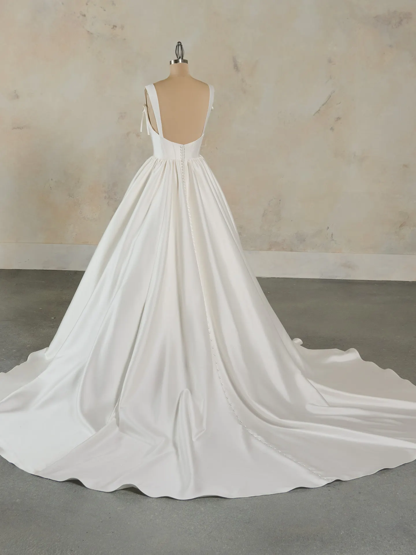 Maggie Sottero Talitha back view with ruffled train and bow.