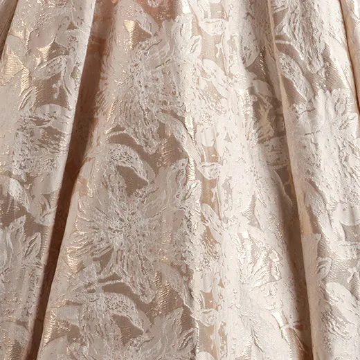 Floral pattern on Derrick Marie ball gown wedding dress fabric close-up.