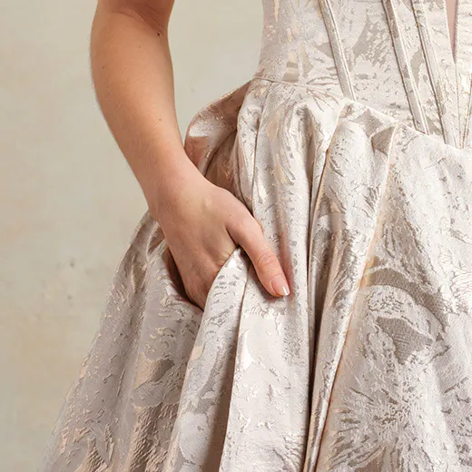Derrick Marie floral ball gown with hand in pocket side view