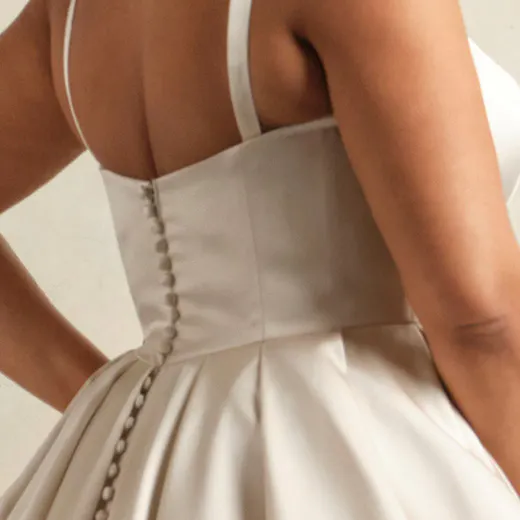 Regal Selena Vida satin wedding gown back view with buttons and pockets