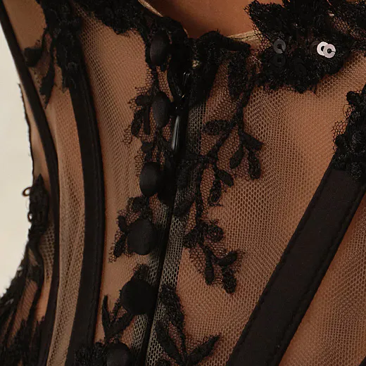 Maggie Sottero Vivica black lace detail on sheer fabric, close-up view.