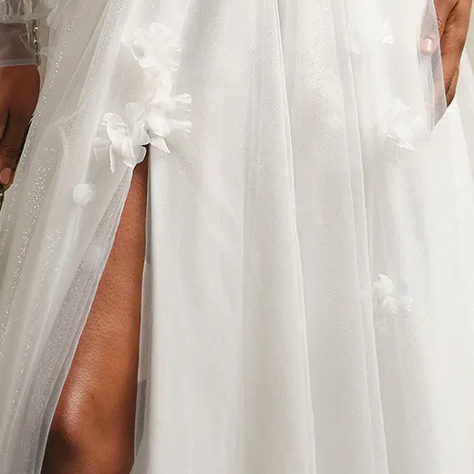 Romantic Allison tulle A-line gown with floral details and slit front view.
