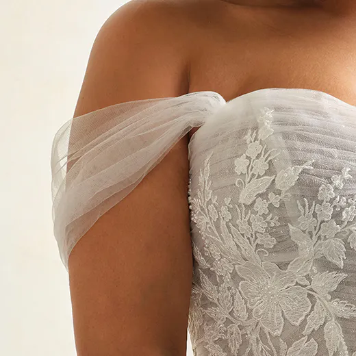Tulle corset with floral lace and pearl detail, off-shoulder style.