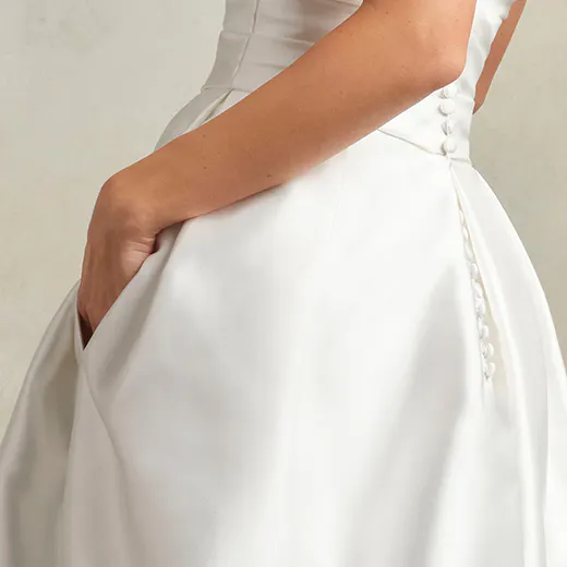 Ethelinda short wedding dress side view showing buttons and pocket.