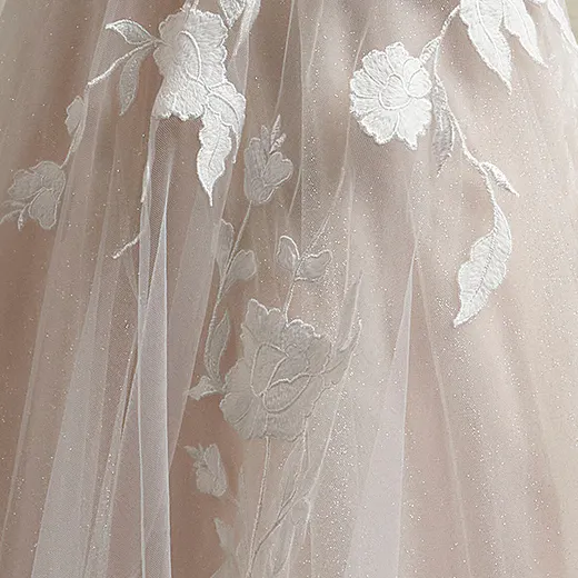 Hattie Leigh gown detail with floral lace on sheer fabric.