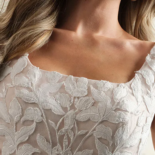 Hattie Leigh square neckline modest wedding gown close-up floral lace detail.