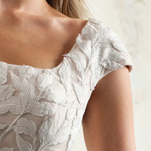 Hattie Leigh square neckline close-up with floral lace detail.