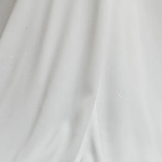 Maggie Sottero dress fabric detail, elegant white material close-up.