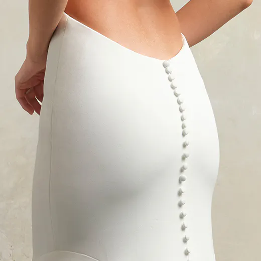 Maggie Sottero Kelsey back view with button detail on a sheer crepe bridal gown.