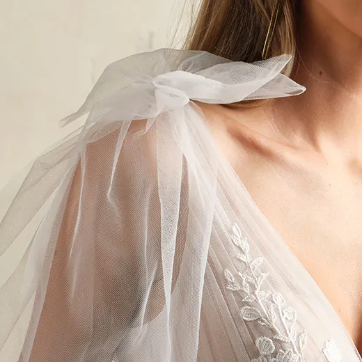 Maggie Sottero Zinnia lace gown detail with flowy tulle shoulder and floral embroidery