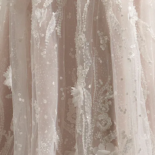 Rebecca Ingram bridal gown with 3D floral details and shimmering accents.