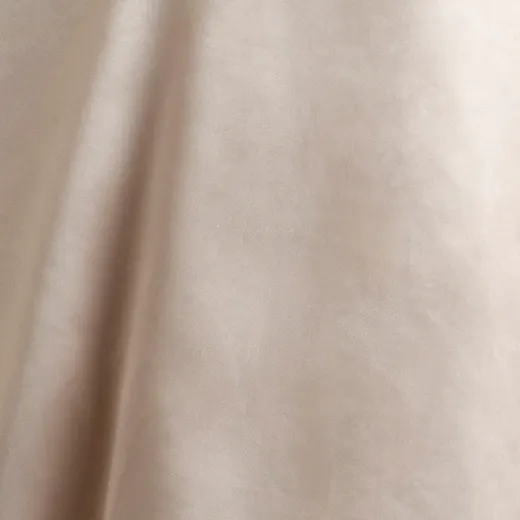 Smooth beige fabric texture, likely part of a bridal gown.